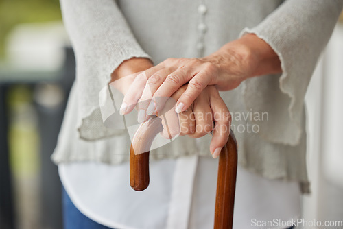 Image of Hands, walking cane and senior woman with disability leaning for help, balance and support at nursing or retirement home. Hand, mature and mobility stick for disabled elderly lady in physical therapy