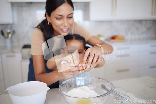 Image of Egg, baking and family with a mother and girl learning how to bake in the kitchen of their home together. Food, kids and cooking with a woman teaching her daughter how to be a chef or cook in a house