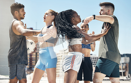 Image of Soccer, sport and fight with a woman player pushing a man athlete during a game or match outdoor on a rooftop. Football, fitness and competition with a team fighting during a sport rivalry