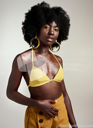 Image of Yellow fashion, makeup and beauty with a black woman model in studio on a gray background for a contemporary photo shoot. Cosmetics, accessories and style with an edgy female posing in trendy clothes