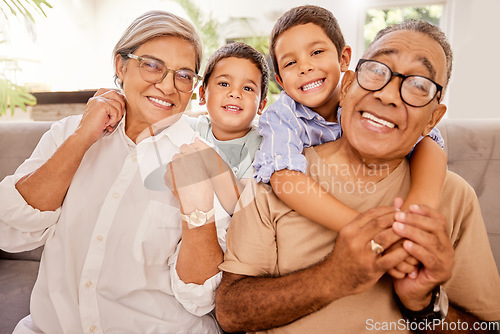 Image of Love, happy family and kids relax with grandparents on a sofa, hug and bonding in a living room. Portrait, seniors and children embracing, laughing and enjoying visit to grandma and pa on the weekend