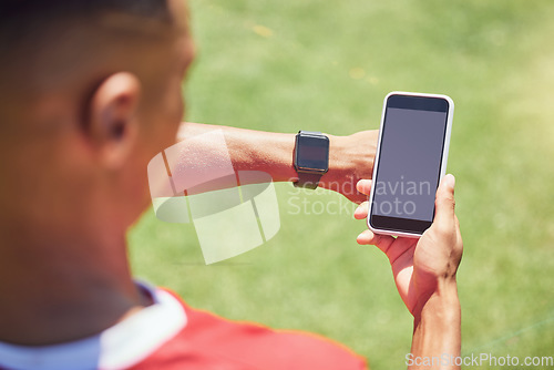 Image of Green screen, soccer player and phone on field with smartwatch, tech or mockup on mobile digital app. Man, football player or smartphone on social media, web or 5g network at training, game or match