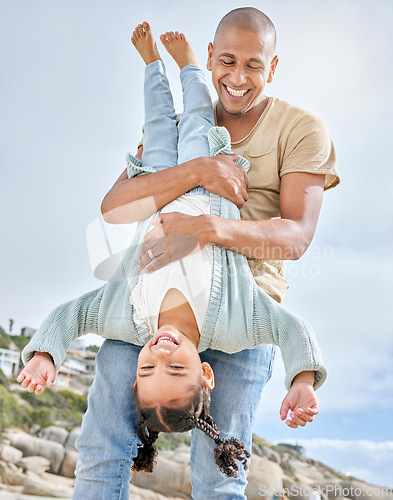 Image of Happy family, beach and father with daughter having fun upside down fun on Florida vacation. Family, girl and parent in carry flip at sea in Mexico, laughing, happy and enjoying their bond in nature