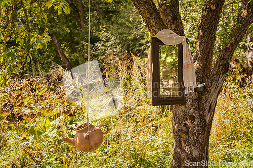 Image of Washstand and mirror on a tree