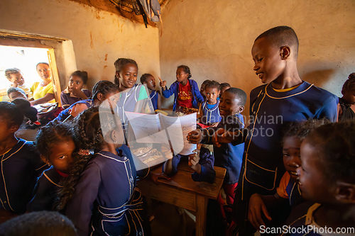 Image of Happy Malagasy school children students in classroom. School attendance is compulsory, but many children do not go to school.