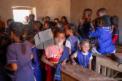 Image of Happy Malagasy school children students in classroom. School attendance is compulsory, but many children do not go to school.