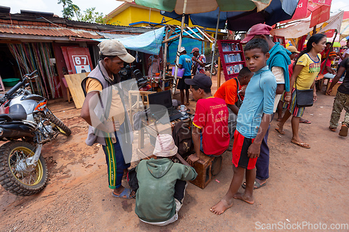 Image of Malagasy man repairs phones on the street. Miandrivazo, Madagascar