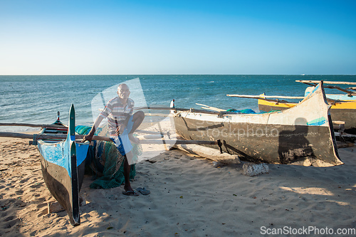 Image of Fishermen resting on sailboats, traditional outrigger canoe in the coast of Anakao in Madagascar