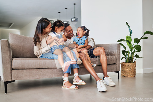 Image of Mother, father and children laughing on sofa together, having fun and bond on weekend. Love, affection and multicultural family on couch in living room. Happy parents playing with kids in family home