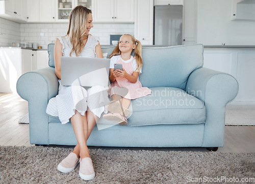 Image of Mother, girl child and digital device happy, learn and smile for bonding, embrace and talking together in living room on couch. Laptop, smartphone and mama with daughter browse online and home school