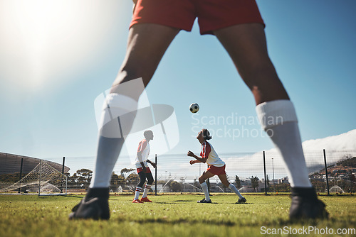 Image of Sports, summer and soccer ball on head, young men on field during training exercise. Health, fitness and ball header at football game, players on grass together for practice workout or competition.