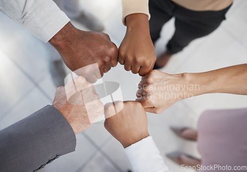 Image of Diversity, hands and team fist above in support, trust and unity for collaboration, agreement or meeting at the office. Group hand of diverse people in teamwork, cooperation and solidarity for fight