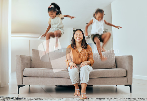 Image of Family, mom and kids jumping on sofa having fun, energetic and hyper at home. Happiness, joy and portrait of mother sitting with excited children jump on couch, play and relax together on weekend