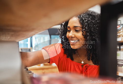 Image of Shelf, store and shopping black woman in grocery shop, choice or select food products. Retail, supermarket and female customer from Nigeria choosing goods in small business, market or grocery store.