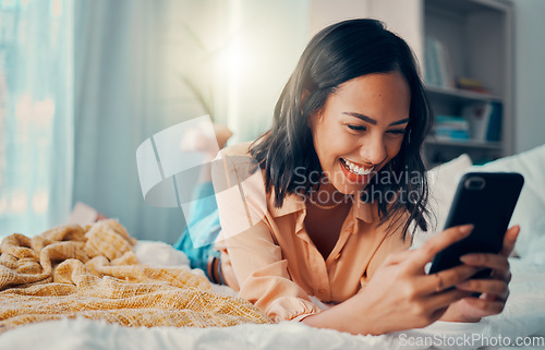 Image of Happiness, social media and woman on bed with phone, smiling, laughing and relaxing at home. Meme, online and girl on smartphone texting, chatting and browsing internet in bedroom to relax on weekend