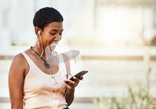 Image of Black woman, smile and smartphone with earphones, music and communication, social media and audio streaming online. African American person, listening to podcast or radio, connection and technology.