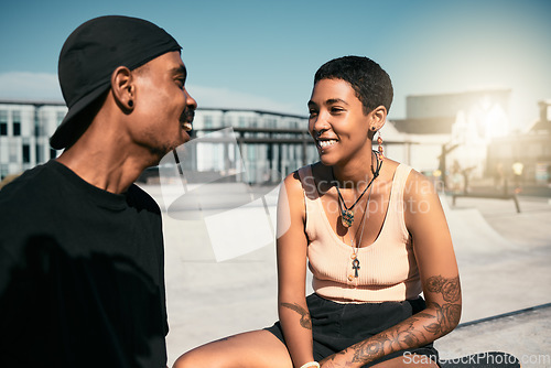 Image of Happy, smile and couple talking in the city while relaxing outdoor together on summer vacation with flare. Happiness, communication and young man and woman from Mexico speaking in a urban town.