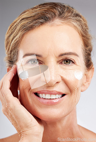 Image of Mature woman, sunscreen or face cream skincare routine on studio background in facial wellness or healthcare or sun protection. Zoom, smile or happy beauty model with spf grooming product or collagen