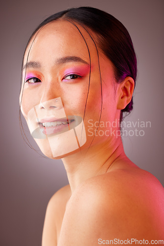 Image of Futuristic makeup, neon and woman for asian beauty, cosmetics glow and creative product in studio light portrait. Skincare vaporwave and ai model from Korea in headshot smile for dermatology mock up