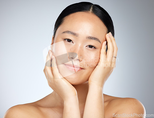 Image of Skincare, beauty and woman with facial wellness against a grey mockup studio background. Face portrait of a young, Asian and happy model with luxury cosmetics from dermatology and mock up space