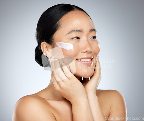 Image of Asian woman, skincare cream and face makeup, sunscreen beauty product and luxury cosmetics wellness on studio background. Happy Japanese model, facial spf lotion and natural aesthetic dermatology