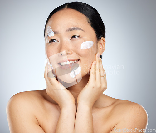 Image of Woman with sunscreen on face in studio, skincare cream product for natural uv protection and cosmetic wellness. Spa advertising beauty facial, happy korean girl with smile and dermatology spf lotion