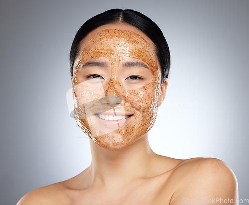Image of Woman with face mask, korean skincare spa with natural sugar scrub product or portrait in gray background studio. Face of happy asian girl, wellness beauty with cleaning exfoliation or facial smile