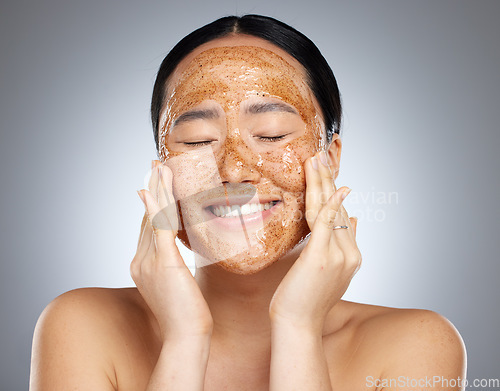 Image of Facial, product and woman skincare face mask cosmetics cleaning smooth and soft skin in Asian studio. Relaxed, smile and happy beauty model peeling a healthy natural grooming scrub or mud in Seoul