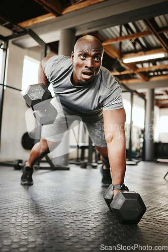 Image of Fitness, gym and black man doing a workout with weights for strength, wellness and training. Bodybuilder, sports and strong African athlete doing push up exercise in a sport, health and active studio