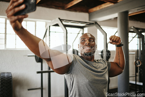 Image of Phone, gym and selfie of black man, exercise and fitness with strong, muscular and smile bodybuilder. Happy instructor with picture, motivated and ready for a good training workout in a health centre