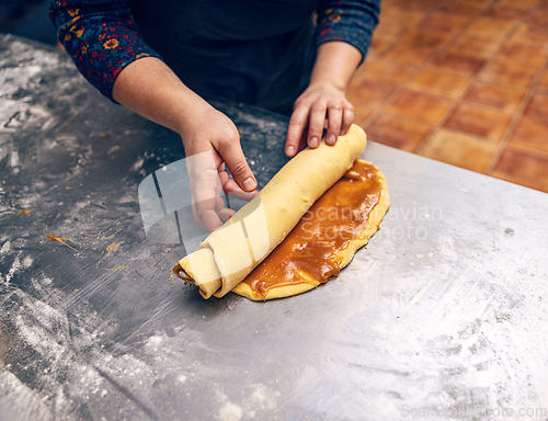 Image of Rolling stuffed dough for make babka.