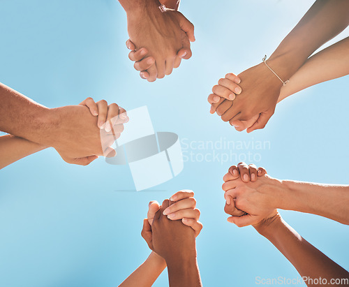 Image of Hands, solidarity and holding hands, support and collaboration, partnership and diversity with blue sky background. Teamwork, unity and group of people, team building and community with trust.