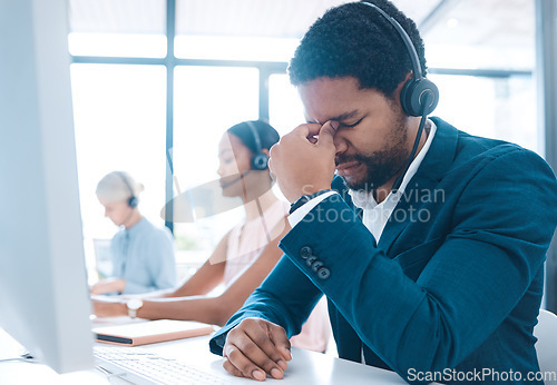 Image of Stress, headache and call center with a man consultant suffering from pain or tension while working in customer service. Contact us, compliance and mental health with a male consulting on a headset