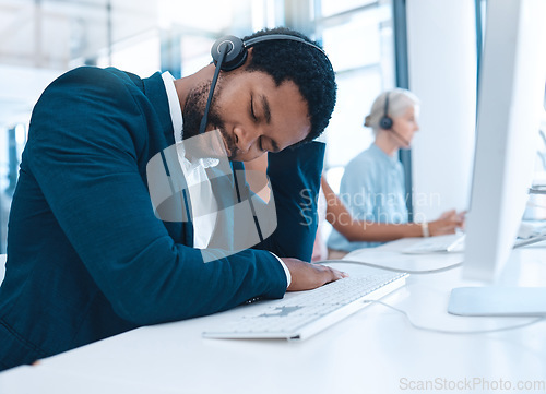 Image of Call center burnout, sleeping man and employee exhausted after long hours, telemarketing or customer service consulting. Company office agent, help desk consultant or contact us worker tired at work