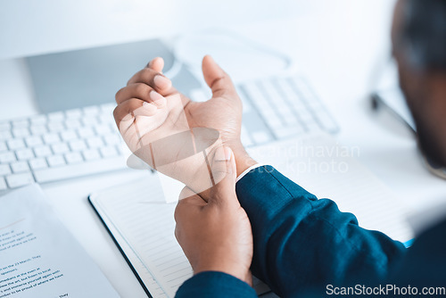 Image of Hands of business man with pain, carpal tunnel syndrome or strain from corporate job, working or typing on keyboard. Arthritis risk, hurt and wrist of black man or office employee with injury problem