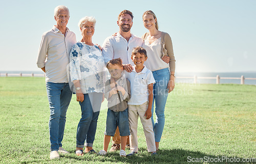 Image of Smile, field and portrait of happy family on grass lawn for outdoor fun, bonding and quality time together in Toronto Canada. Happiness, vacation and big family of grandparents, parents and children