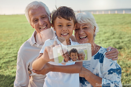Image of Phone, selfie and happy grandparents with child outdoor in nature on family picnic together. Happiness, smile and elderly man and woman in retirement taking picture on smartphone with boy grandchild.