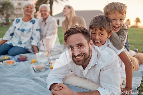 Image of Family picnic in garden, father with kids in outdoor park and healthy food for snack with grandparents support. Children playing with dad on grass, parents on weekend and big family vacation together