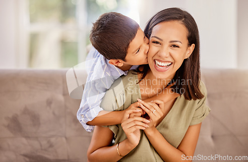 Image of Kiss, mother and child with hug for love, care and gratitude on mothers day on the sofa of the living room in their house. Portrait of a happy, young and mom with a smile for affection from her kid