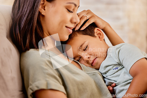 Image of Cuddle, mother and child with smile on the sofa in the living room for love, peace and relax together in their house. Happy, calm and mom with care and hug for a kid on the couch in their family home