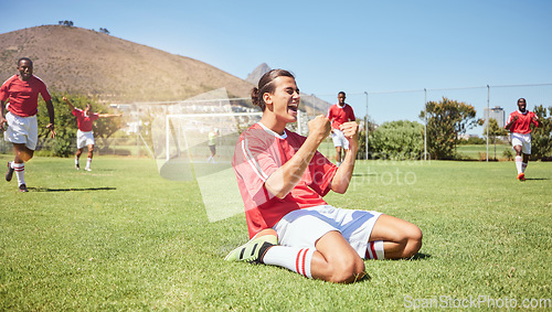 Image of Soccer player, cheering and winner fist in game success, community match or energy workout training. Smile, happy and celebration for football player, men or sports friends on competition grass field
