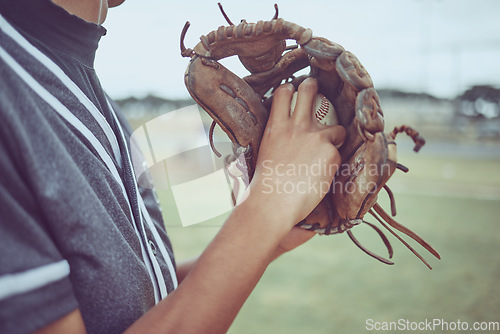 Image of Baseball player, hands or ball in mitt on grass field for fitness, workout and training in game, match and competition. Zoom, baseball glove and sports athlete in energy exercise for softball pitcher