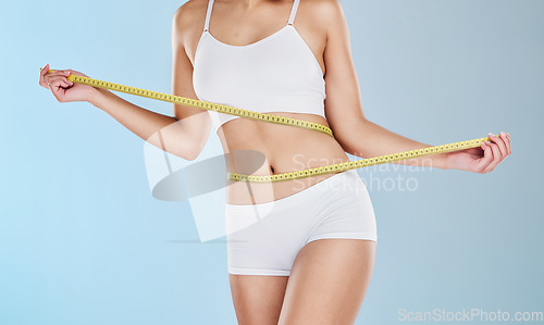 Image of Health, diet and body of woman with tape measure to track progress, check fitness results and measure waist, stomach or abdomen. Weight loss motivation, wellness lifestyle and slimming self care girl