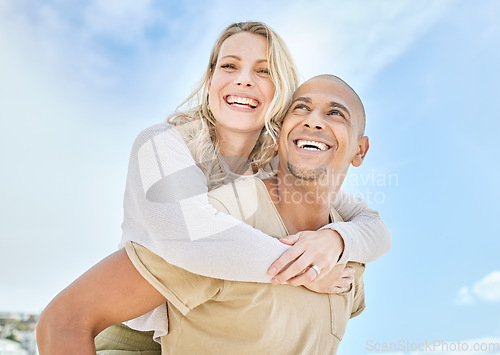 Image of Woman, interracial couple and piggy back with love, happiness and fun in the sun outdoor. Happy people relationship with a smile in the sunshine together on travel and summer vacation with a blue sky