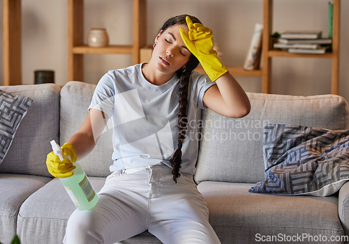 Image of Spring cleaning, tired and sad woman headache in home living room with burnout, stress and frustrated spray task. Fatigue, pain and depression, housekeeping cleaner and exhausted maid service problem