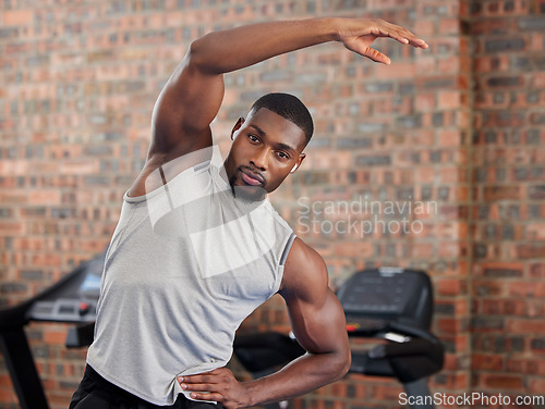 Image of Exercise, black man and stretching for workout, fitness and wellness being healthy, in sportswear and in gym with focus face. African American trainer, athlete or male for health, cardio and training