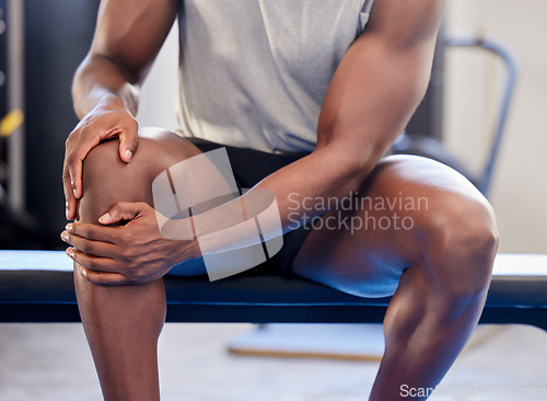 Image of Knee pain, fitness and sports black man injury at gym after workout exercise. Closeup male athlete orthopedic problem, fibromyalgia emergency and medical arthritis during leg training at health club