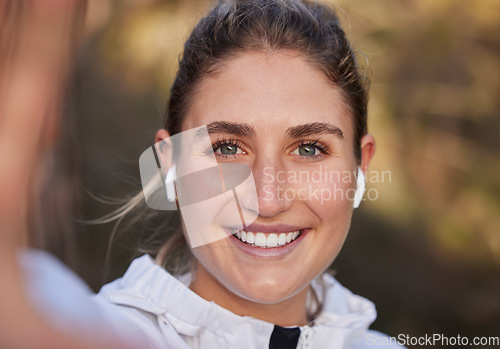 Image of Earphones, face or woman in fitness selfie, training or workout in nature environment, forest woods or garden park. Zoom, portrait or happy smile for runner in sports influencer photograph with music