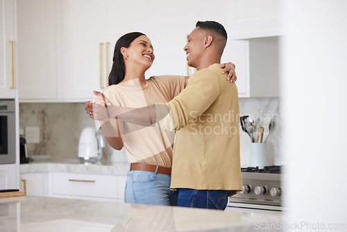 Image of Love, smile and couple dance in kitchen, celebrating anniversary and bonding. Happy, man and woman dancing, romance and affection, carefree or playful people having fun spending time together in home