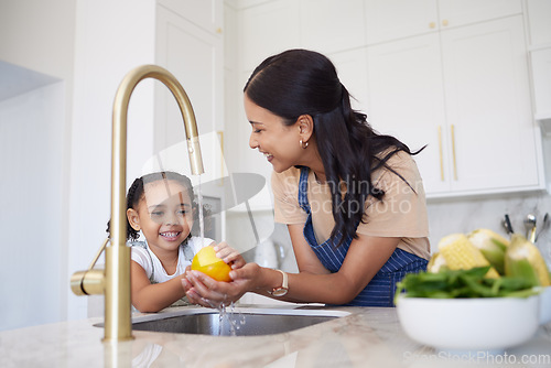 Image of Vegetable, family and washing with a girl and mother cleaning a pepper in the kitchen of the home together for hygiene. Kids, health and cooking with a woman and daughter using a basin to rinse food